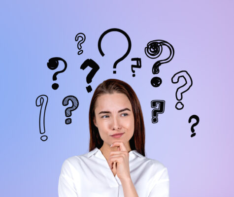 Businesswoman portrait with curious and pensive look, set of question marks Image: ImageFlow/stock.adobe.com