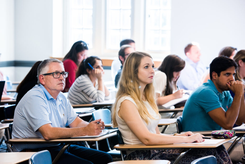 Students sit in Dr. Sheena Murray's Economics for Managers class in Fletcher Hall.