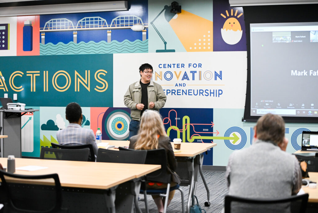 Man addresses crowd in the Center for Innovation and Entrepreneurship at UTC.