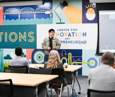 Man addresses crowd in the Center for Innovation and Entrepreneurship at UTC.
