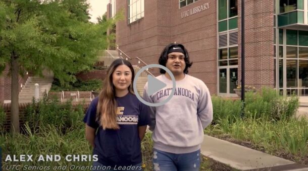 Orientation leaders, standing in front of the UTC Library, welcome incoming Mocs to UTC