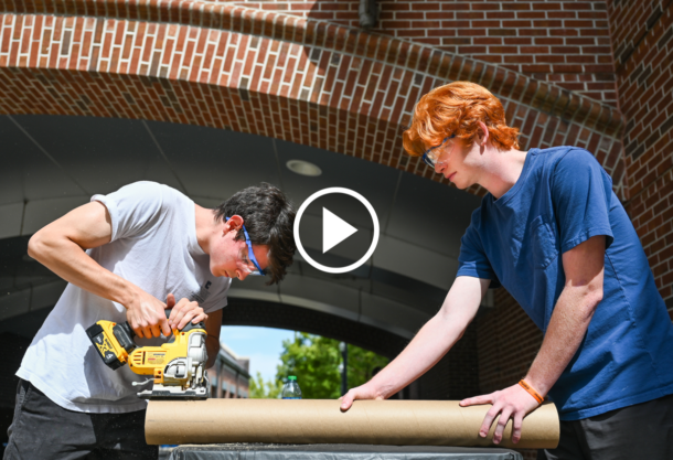 Rocket Mocs team members Mat Ormaza, left, and Elijah Schmiesing-Joyce work on their certification rockets.