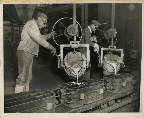 Photograph of two employees using machines in a factory to pour liquid into casts. This is likely at Wheland Foundry, located at South Broad and 28th Street. The back of the photo bears a stamp for Roy Tuley Studio in Chattanooga. Courtesy of the Chattanooga Public Library and University of Tennessee at Chattanooga Special Collections.