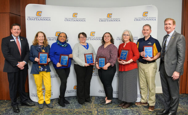 From left: Vice Chancellor for Finance and Administration Brent Goldberg, Angela Foster, Ann Laster, Sandra Cordell, Emily Rosenquist, Kimberly Thomas, Joseph McCauley and Chancellor Steven Angle