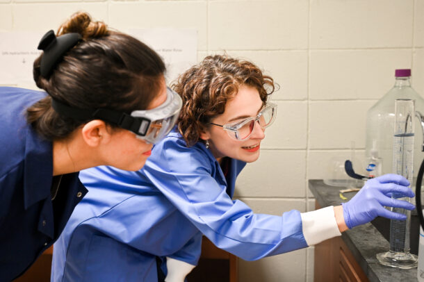 Junior Sam Doss-Watson, left, an environmental geology student, learns from Dr. Ashley Manning-Berg in her Grote Hall lab.
