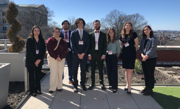 Posters at the Capitol research presenters Amanda Lesswing, left, Meredith Grant, Juan Peña, Ward Metcalfe, Nathanael Moore, Gillian Morton, Christina Harris and URaCE Program Administrator Caitlin Kelley. Photo courtesy of Caitlin Kelley.