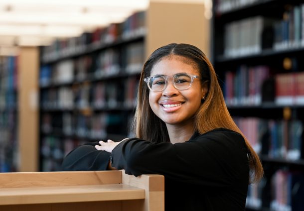 Devyn Johnson stands in the UTC Library