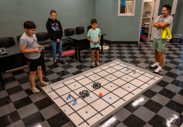 STEAMagination’s different stations included a miniature soccer game featuring robot players. Photo by Noah Camacho.