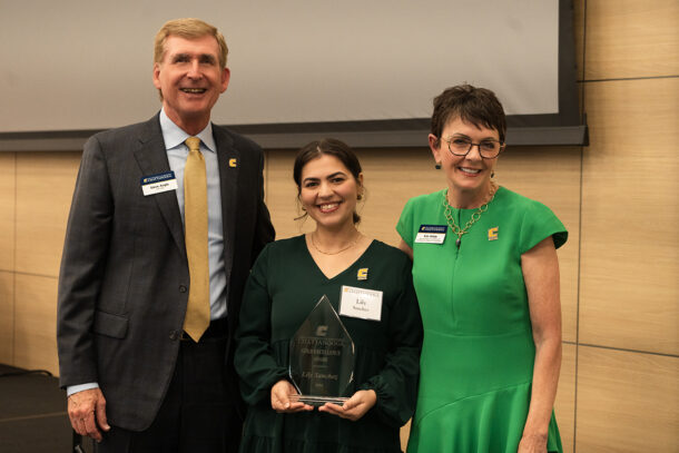 Chancellor Steve Angle and Vice Chancellor Kim White present Lily Sanchez (‘16) with the 2024 GOLD Excellence Award. 