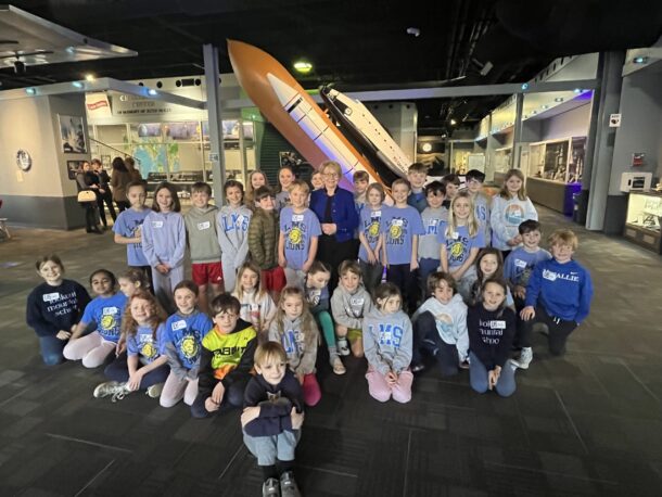 Dr. June Scobee Rodgers poses with third-grade students at the UTC Challenger STEM Learning Center. 