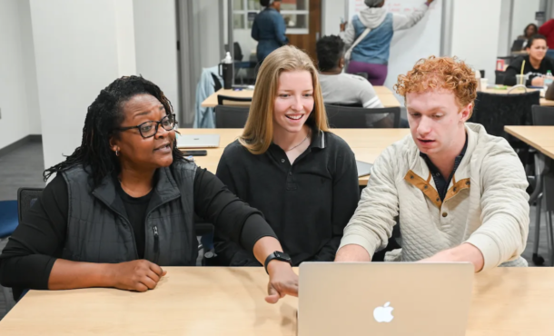 Local business owner Shawanna Kendrick, left, works with Urban Vision Initiative student consultant interns Ana Morris and Graham Davis.