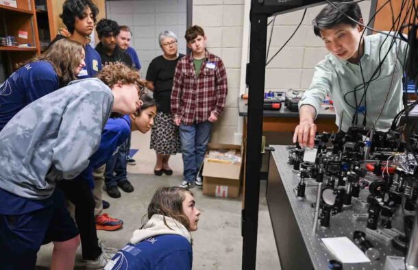 Dr. Tian Li leads a Quantum Camp demonstration in Grote Hall. 