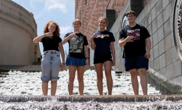 UTC Honors College students Izebella Lamb, left, Summer Wilson, Lilliana Jessen and Andrew Capelety flash the Power C while standing on the famous “water steps” in downtown Chattanooga as part of City as Text.