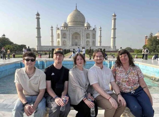 From left: Donovan Scott, Thomas Lynberg, Emma Ward, Brandon Pruitt and Associate Professor Jaclyn Michael sitting in front of the Taj Mahal. Photo courtesy of Dr. Jaclyn Michael.