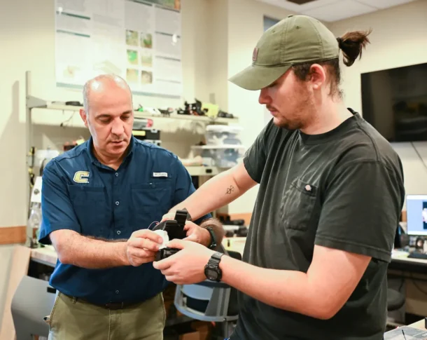 Dr. Erkan Kaplanoglu and graduate student Chase Guttu demonstrate their device in the Engineering and Computer Science Building.