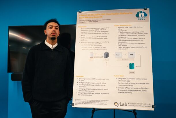 Fabion Walden stands next to his poster titled “A Secure and Scalable SMS Classification Platform for Scam Warning Research.” Photo courtesy of Fabion Walden.