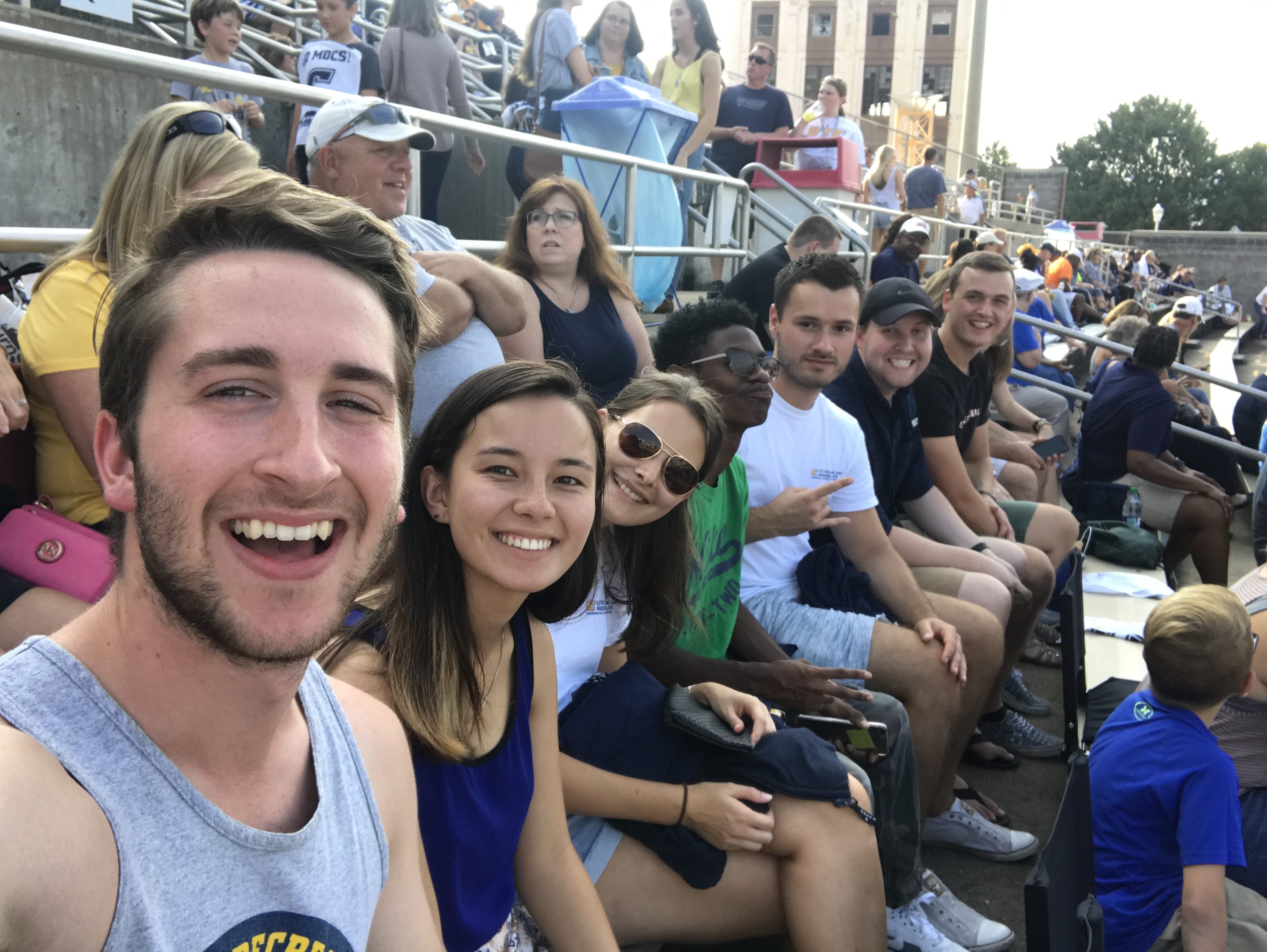 Students Will Patterson, Jessica Niell, and more pose for a selfie at UTC's football game.