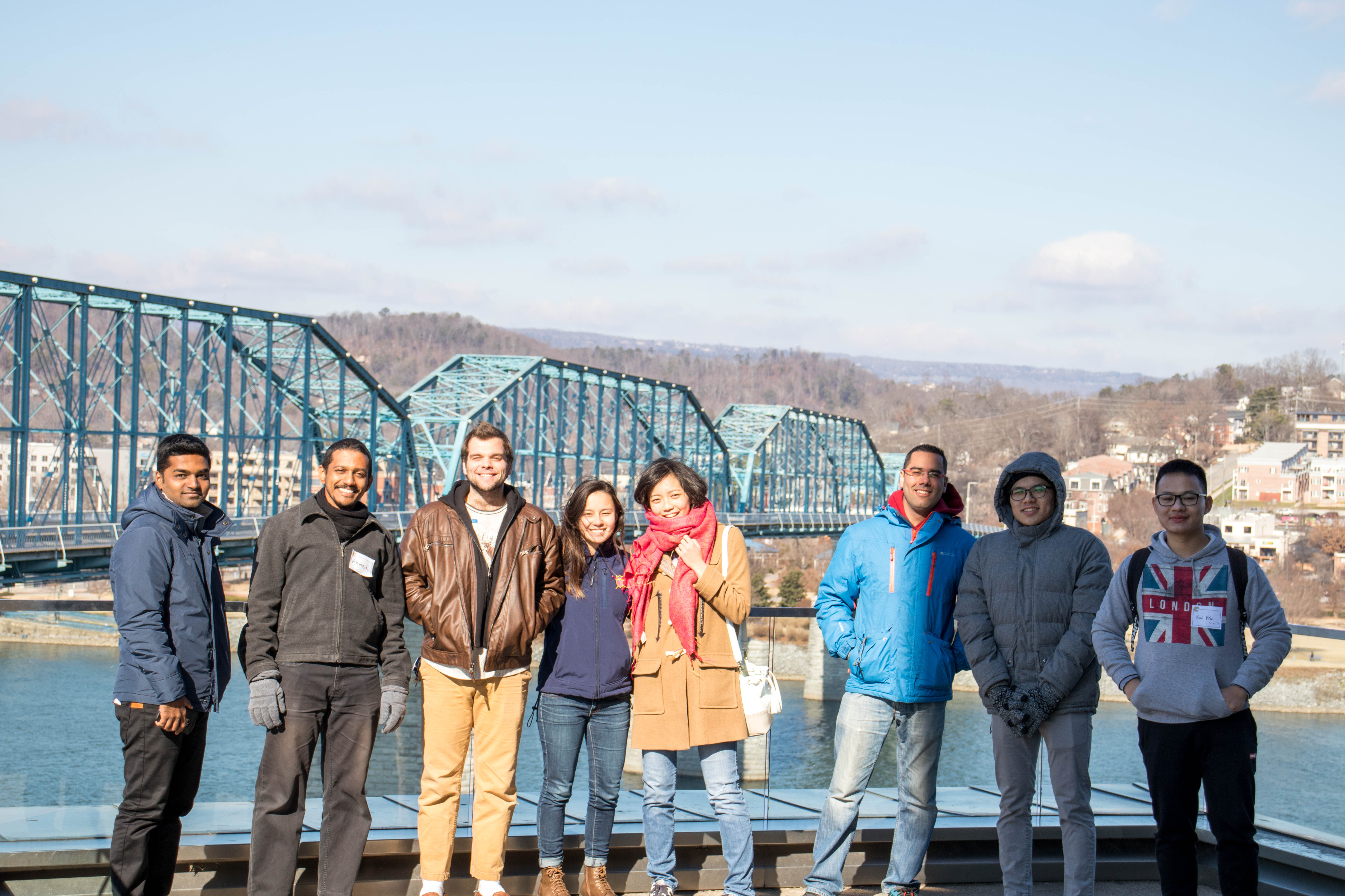 Ahmed (second from left) and his fellow UTC students in front of the walking bridge and the Tennessee river.