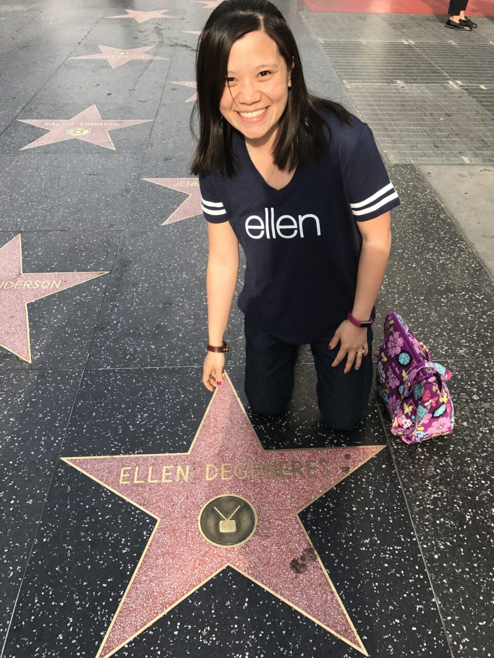 Pato is smiling and crouching over Ellen DeGeneres' star on the Hollywood Walk of Fame