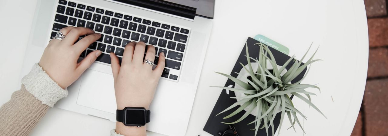 hands typing on a laptop