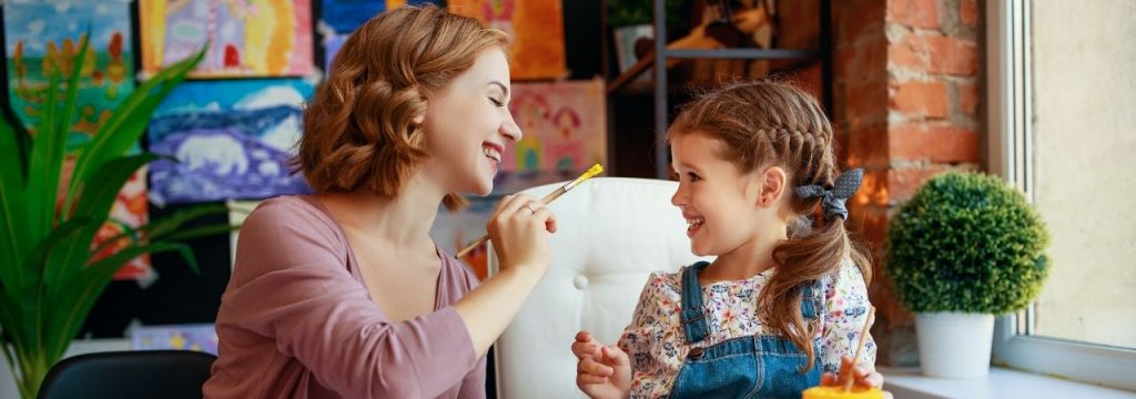 mom and daughter painting together