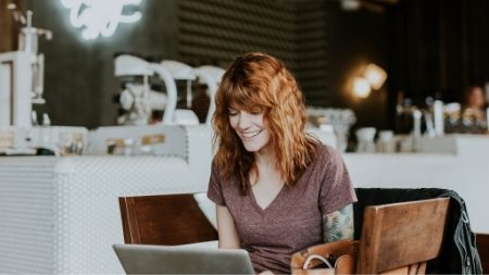 woman working on laptop at a coffee shop
