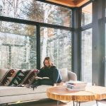 girl reading a book while sitting on her couch