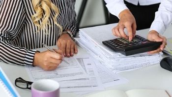 two bookkeepers working on paperwork