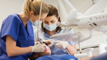 female dental assistant assisting a female dentist