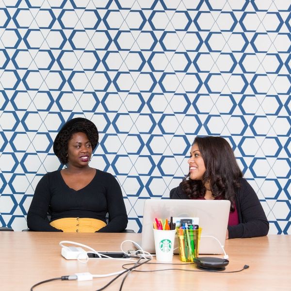 three woman having a meeting in an office