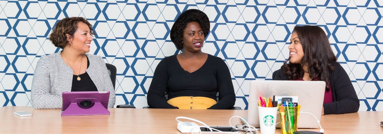 three woman having a meeting in an office