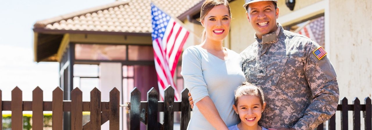 military family in front of a flag