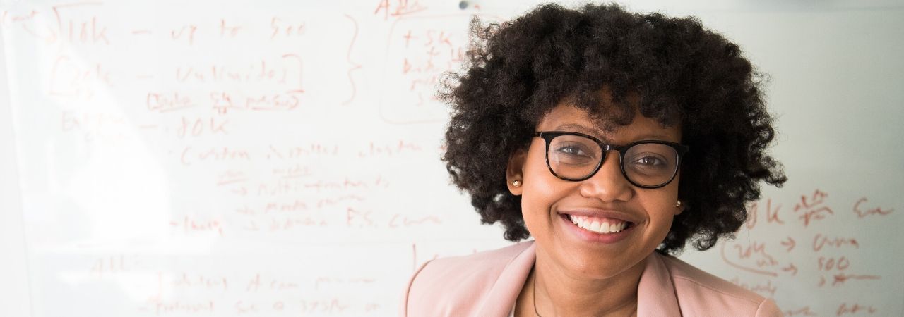 African-American female teacher at a whiteboard