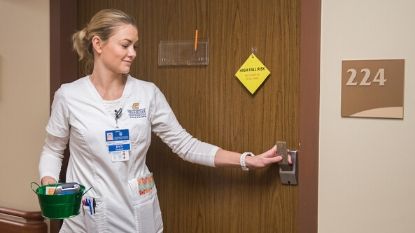 female nurse exiting a hospital room
