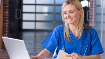female coder working on a laptop