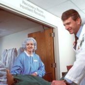doctor and nurse talking to a patient