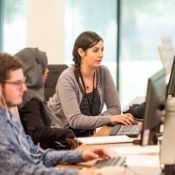 woman helping another woman with her computer