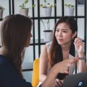 a woman listening to another woman intently