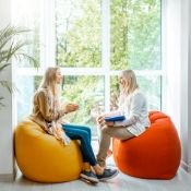 a female therapist having a session with a young woman while sitting on exercise balls