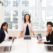 a woman leading a team meeting at an office