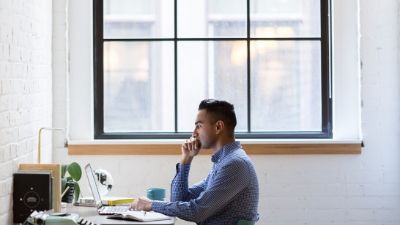 man staring intensely at a laptop computer