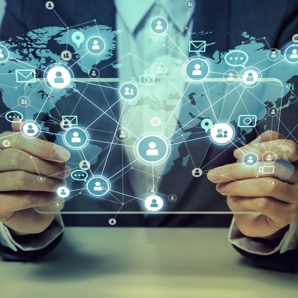 a man holding a silhoutted tablet with a mixed media social networking concept design on it