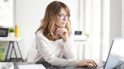 woman intently staring at her laptop