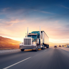 American style truck on freeway pulling load