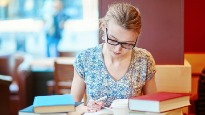 female student reading textbooks
