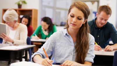 female student taking notes in class