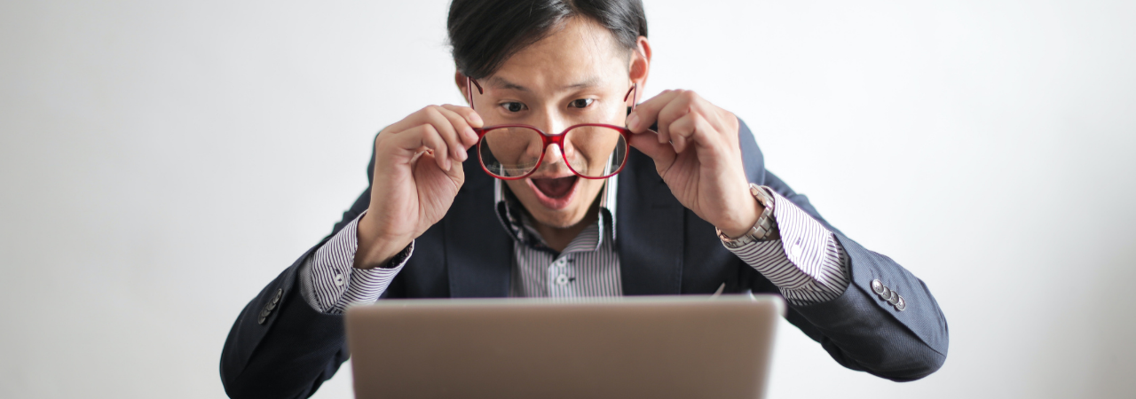 male looking at computer screen amazed