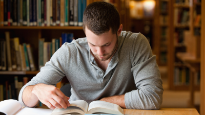 male student reading a book
