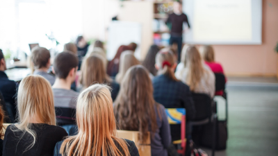 students in a packed classroom facing the teacher