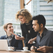 Multiracial contemporary business people working connected with technological devices like tablet and laptop, talking together